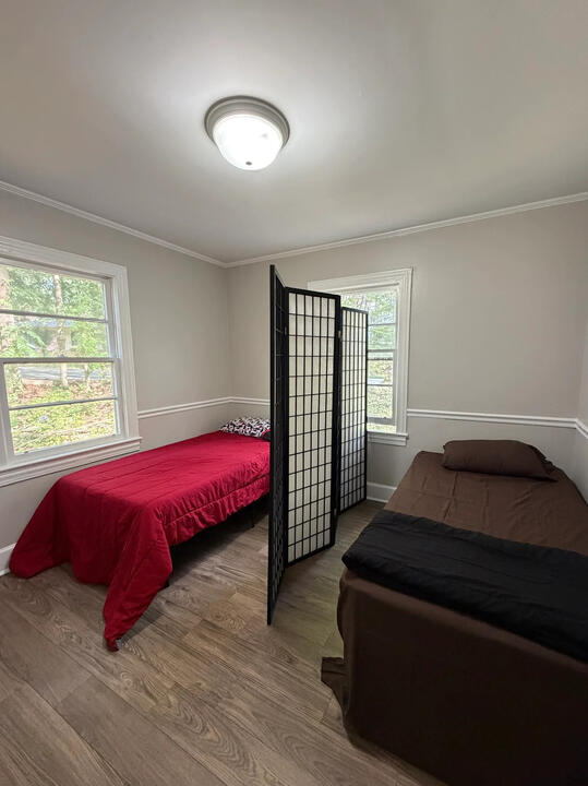 Pasadena Avenue furnished shared room with two beds, a room divider, and sunny windows
