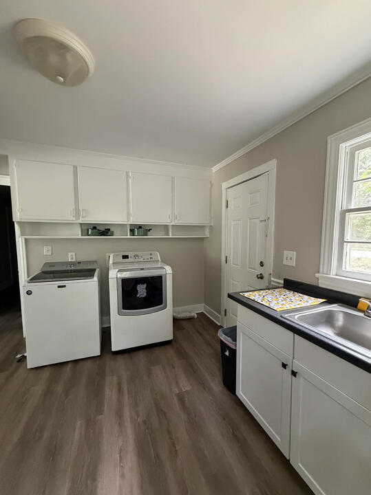 Pasadena Avenue kitchen with white cabinets, a sink, and a washer and dryer