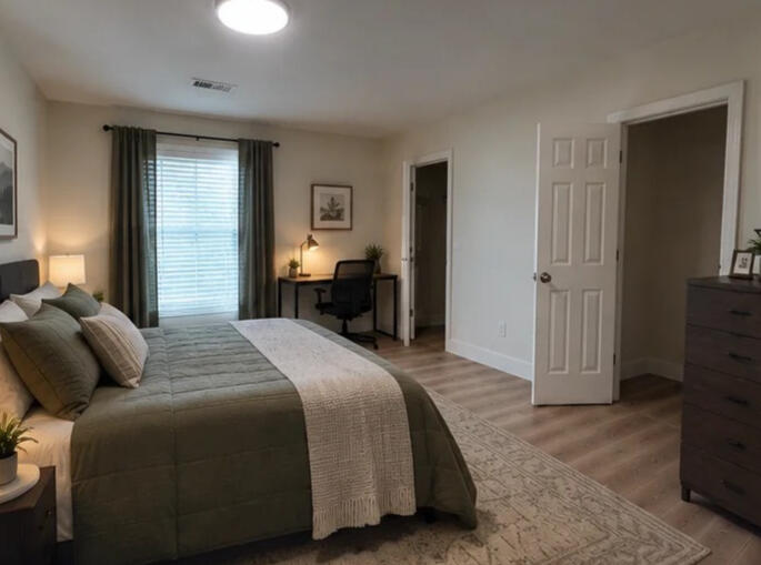 Crestone Drive — close to the city, comfortable at home Furnished bedroom at the Crestone Drive home, with a desk and seating area